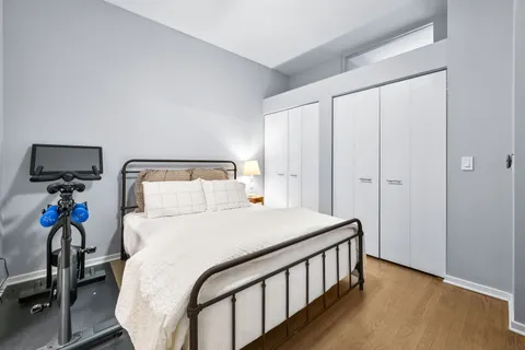 a bedroom with a bed and a chandelier
