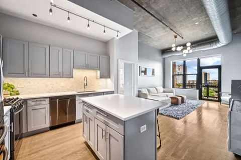 a kitchen with a stove sink and cabinets