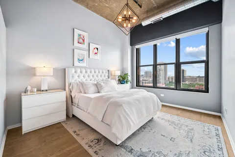 a bed room with a bed and a large window