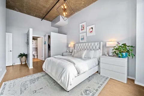 a spacious bedroom with a bed and a couch