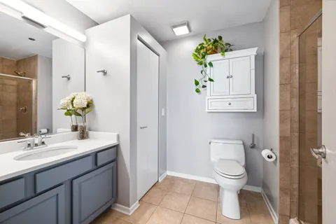 a bathroom with a sink mirror and toilet