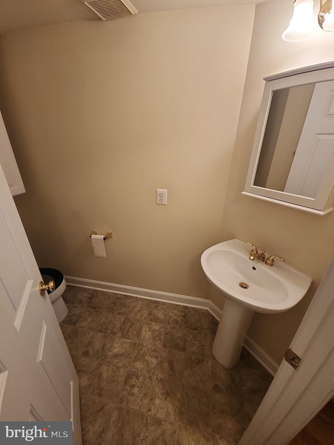 6681 Debra Lu Way Springfield, VA 22150 - Photo 25 of 57 a bathroom with a sink a toilet and mirror