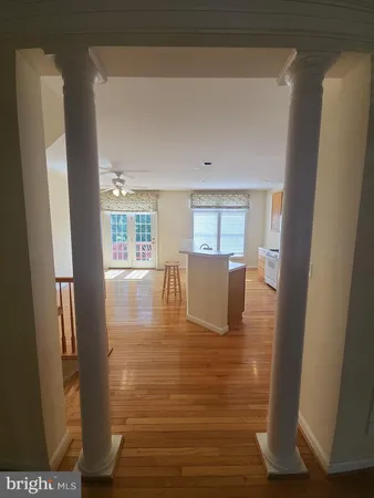 a view of kitchen with wooden floor and electronic appliances