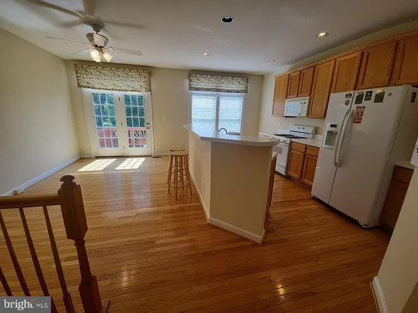 a kitchen with sink refrigerator and window