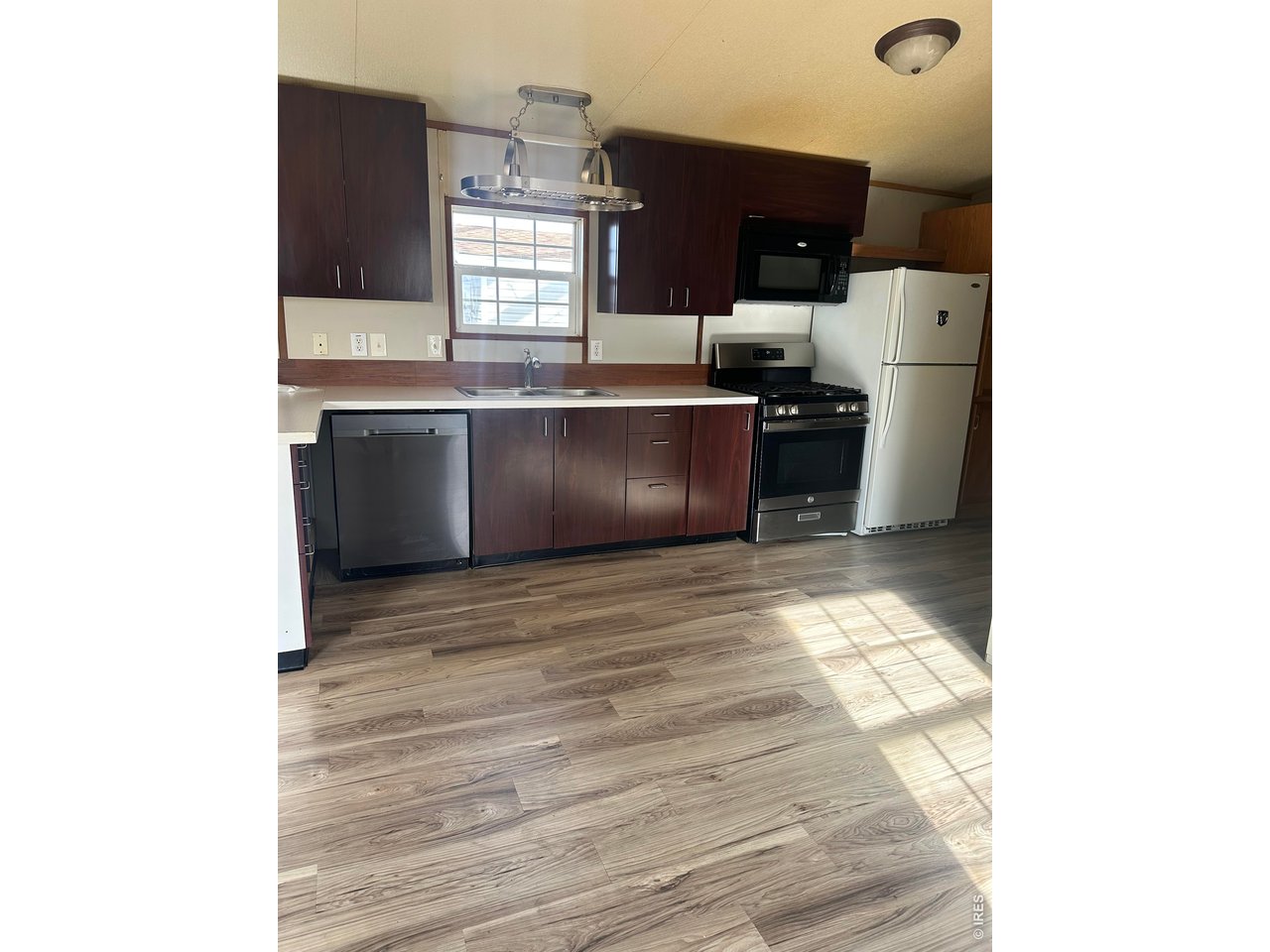 17190 Mt Vernon Road, Unit 3 Golden, CO 80401 - Photo 5 of 10 a kitchen with stainless steel appliances granite countertop a sink and a stove