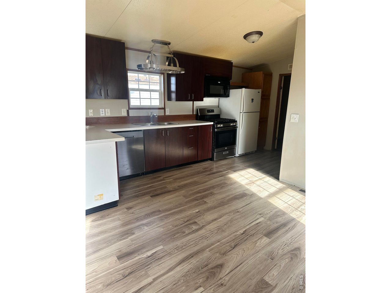 17190 Mt Vernon Road, Unit 3 Golden, CO 80401 - Photo 6 of 10 a kitchen with stainless steel appliances granite countertop a sink refrigerator and cabinets