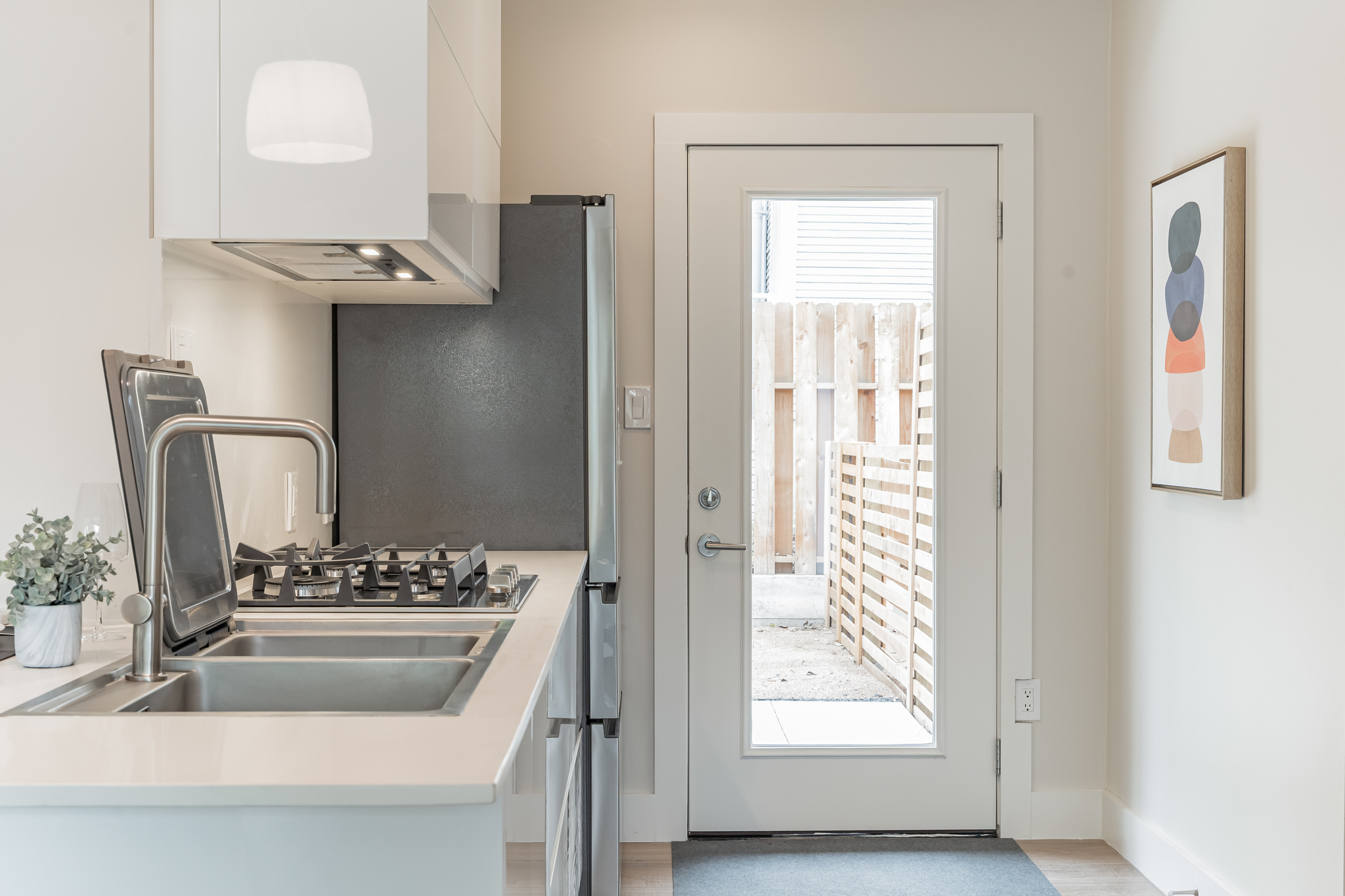 2201 Leon Street Austin, TX 78705 - Photo 18 of 30 A well-appointed kitchen features a gas cooktop, sleek range hood, and convenient outdoor access.