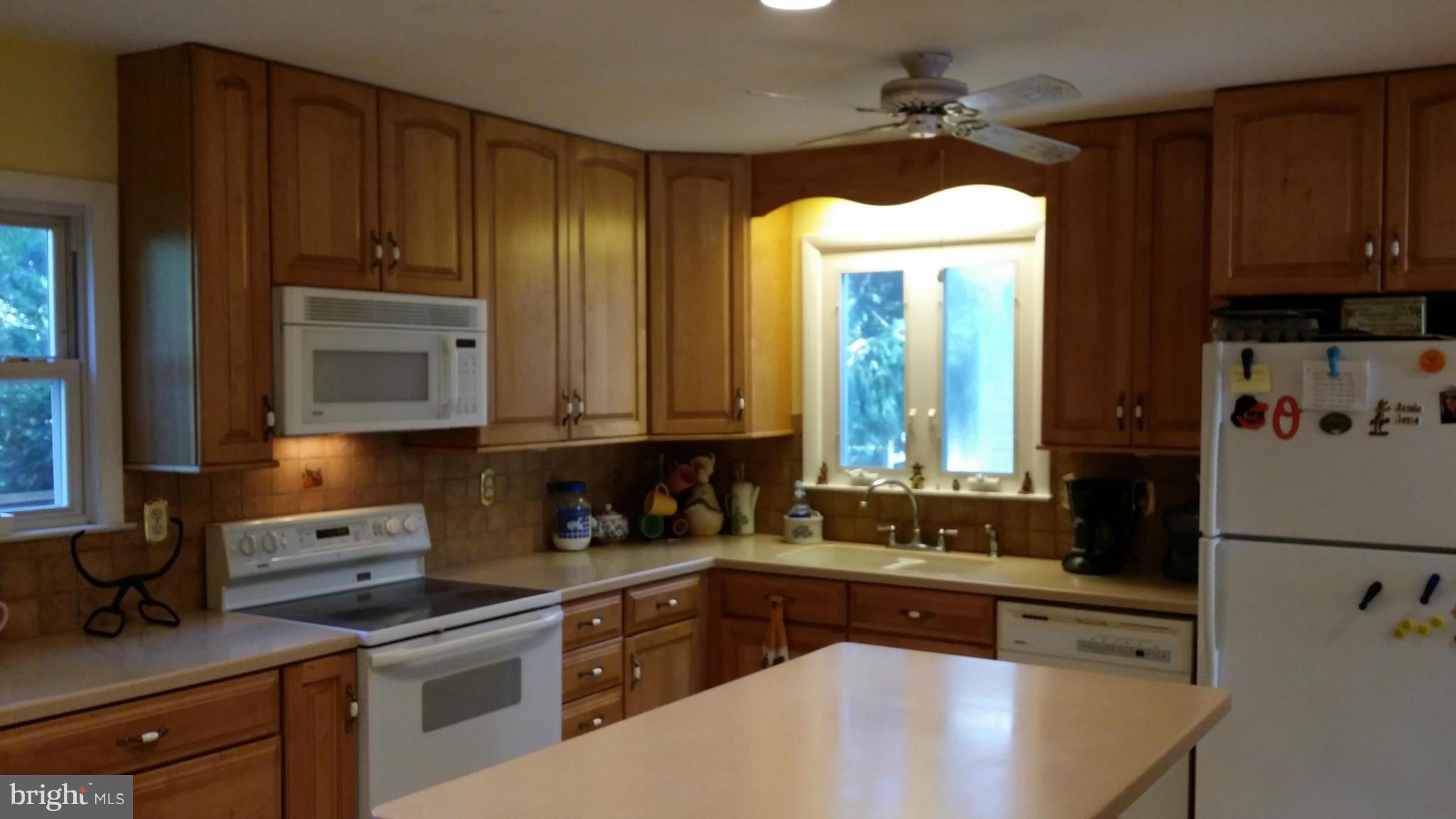 2448 Appleton Road Elkton, MD 21921 - Photo 14 of 29 a kitchen with granite countertop wooden cabinets and white appliances