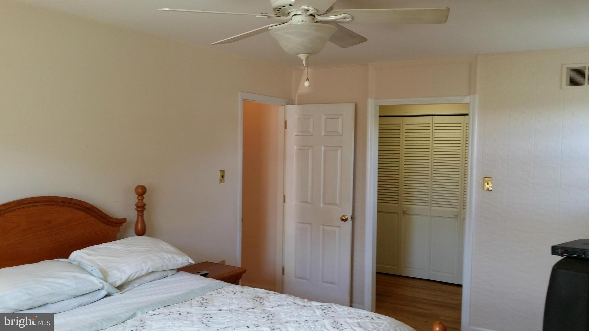 2448 Appleton Road Elkton, MD 21921 - Photo 21 of 29 a bedroom with a bed and a chandelier
