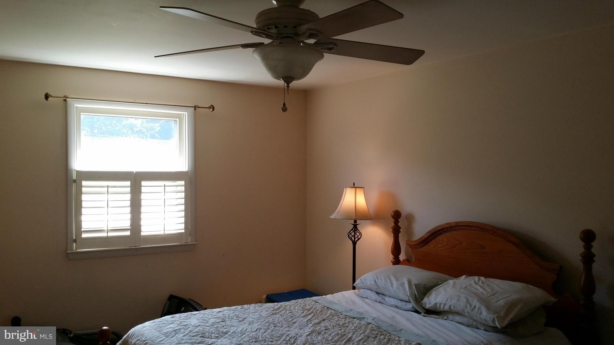 2448 Appleton Road Elkton, MD 21921 - Photo 22 of 29 a bedroom with a bed and a lamp on the dresser
