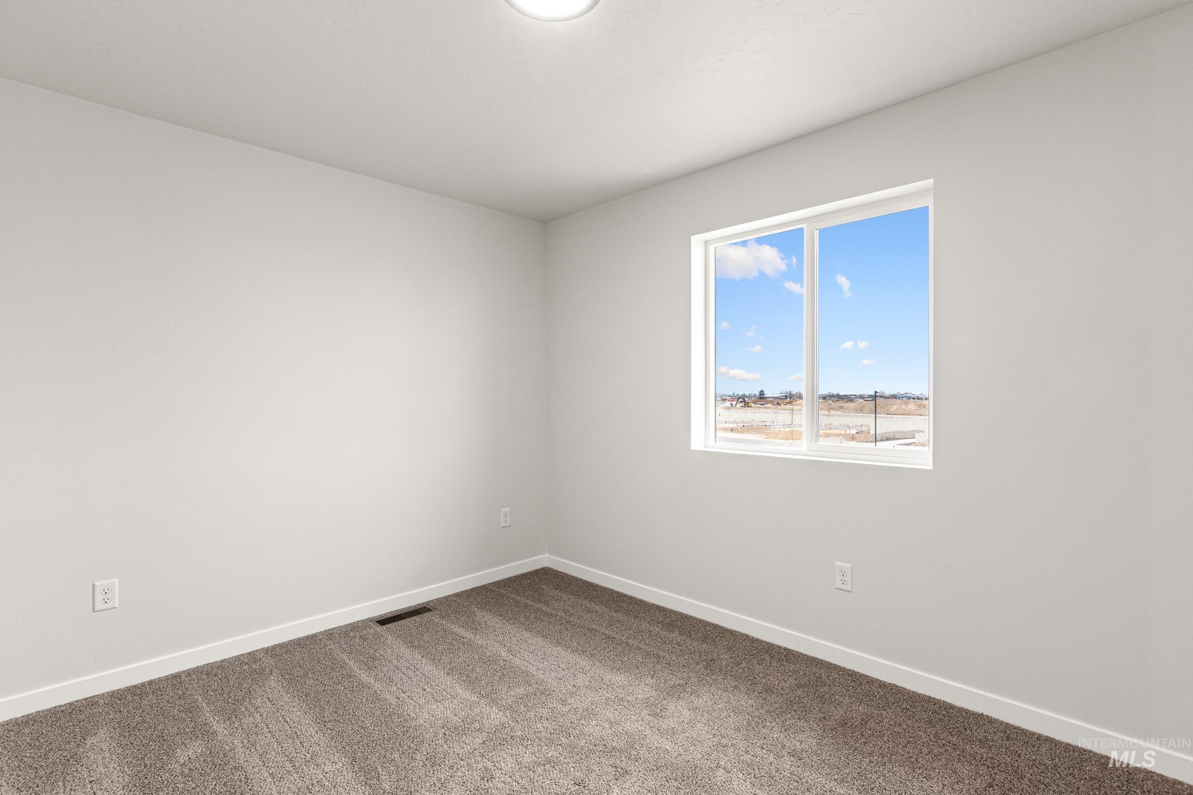 10824 Rutland Street Caldwell, ID 83605 - Photo 10 of 20 Unfurnished room featuring baseboards and dark carpet
