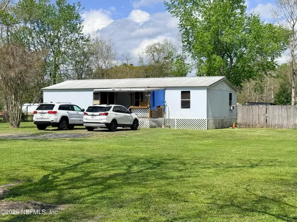 a front view of house with yard and trees