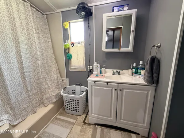 a bedroom with a bed and dresser