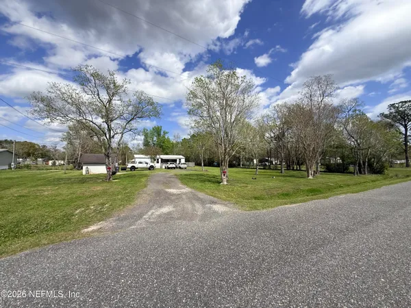 a car parked in front of a house with a yard