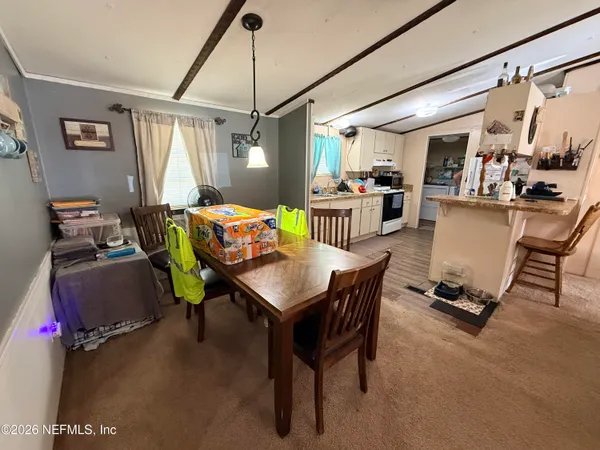 a kitchen with sink refrigerator and cabinets