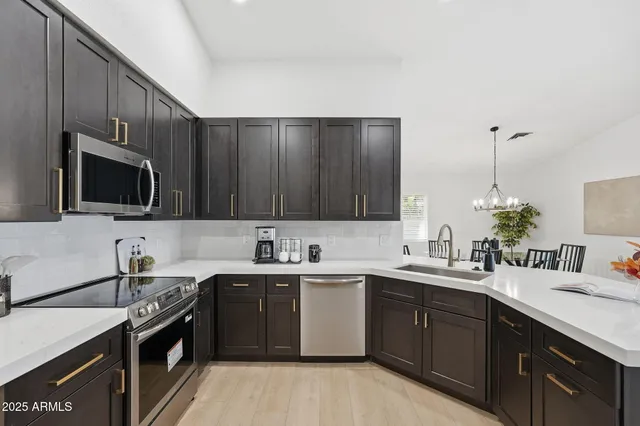 a kitchen with a sink stove and microwave
