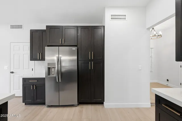 a kitchen with metallic refrigerator freezer and a dishwasher