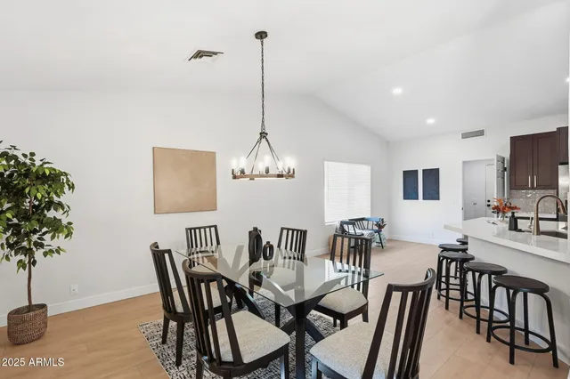 a view of a dining room with furniture and chandelier