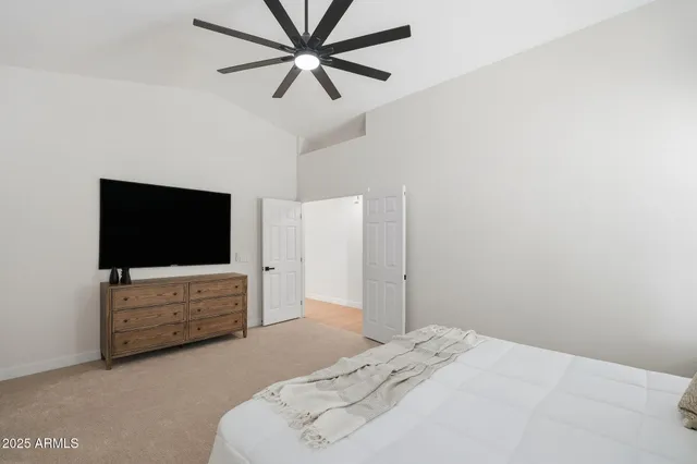 a bedroom with a bed and a flat screen tv