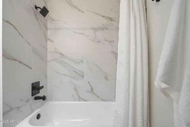 a bathroom with a bathtub and a shower