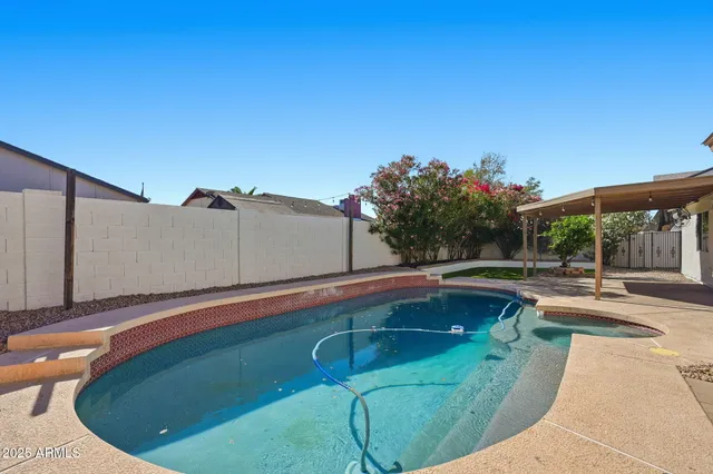 a view of a swimming pool with a yard