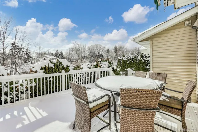 a view of a roof deck with furniture