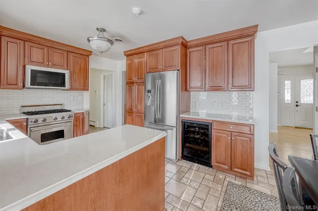 a kitchen with granite countertop a refrigerator stove and sink