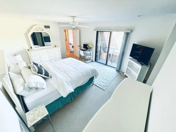 a bedroom with a large bed and a large window