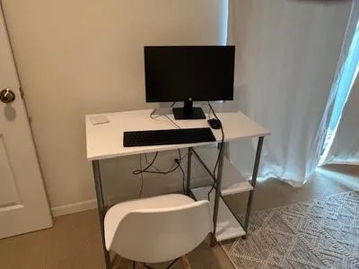 a view of a workspace with furniture
