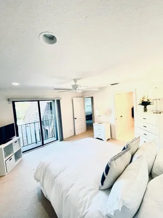 a bedroom with a large bed and a window