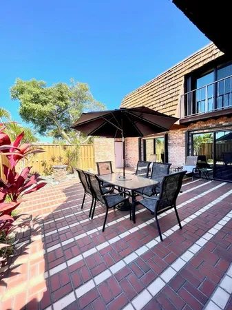 a backyard of a house with table and chairs