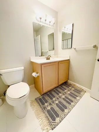 a bathroom with a toilet sink and mirror