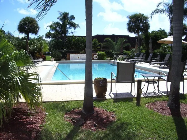 a view of a backyard with sitting area