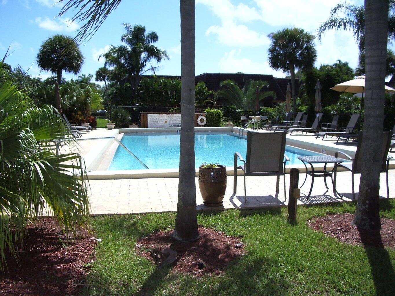 1420 Ocean Way Drive, Unit 32C Jupiter, FL 33477 - Photo 22 of 25 a view of a backyard with sitting area