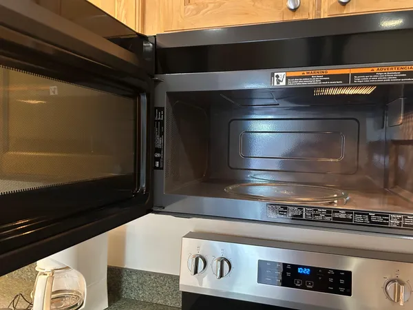 a stove top oven sitting inside of a kitchen