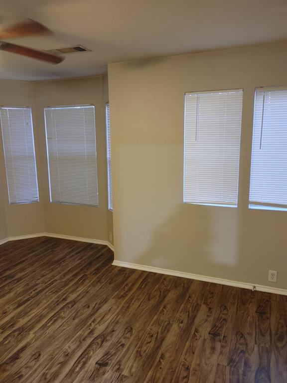 2645 Ezekial Way Plano, TX 75074 - Photo 12 of 16 a view of an empty room with wooden floor and a window