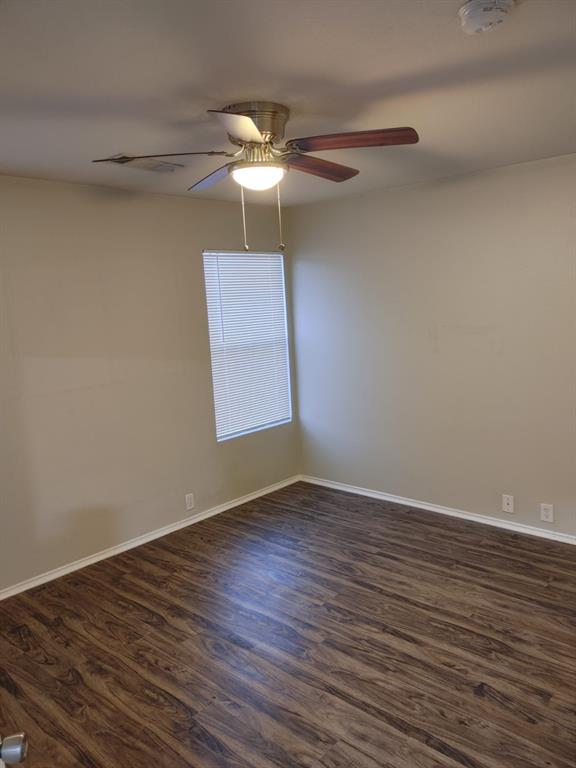 2645 Ezekial Way Plano, TX 75074 - Photo 14 of 16 a view of an empty room with wooden floor and a window