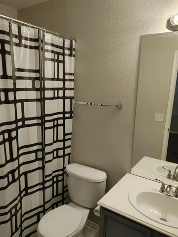 a white toilet sitting next to a bathroom sink