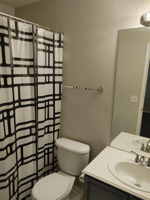 2645 Ezekial Way Plano, TX 75074 - Photo 15 of 16 a white toilet sitting next to a bathroom sink