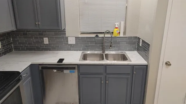 a kitchen with a sink and cabinets