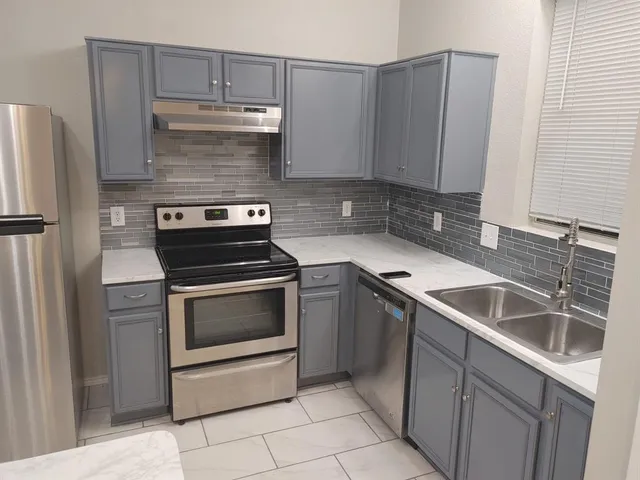 a kitchen with a stove and a microwave