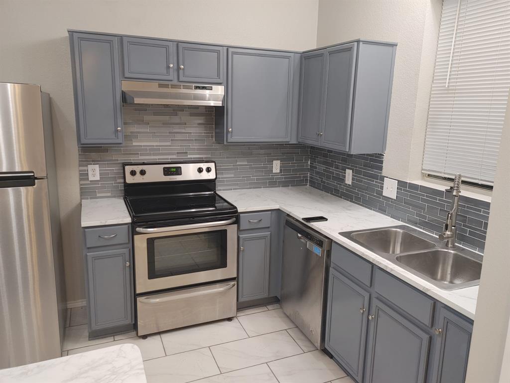 2645 Ezekial Way Plano, TX 75074 - Photo 6 of 16 a kitchen with a stove and a microwave