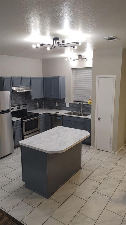 2645 Ezekial Way Plano, TX 75074 - Photo 7 of 16 a kitchen with stainless steel appliances granite countertop a stove a sink and a refrigerator
