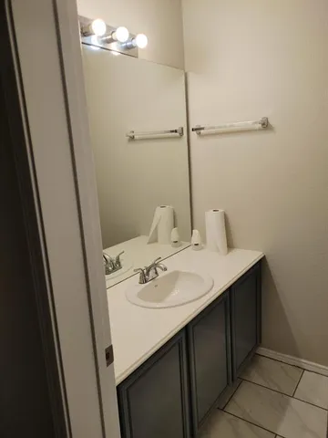 a bathroom with a sink and mirror