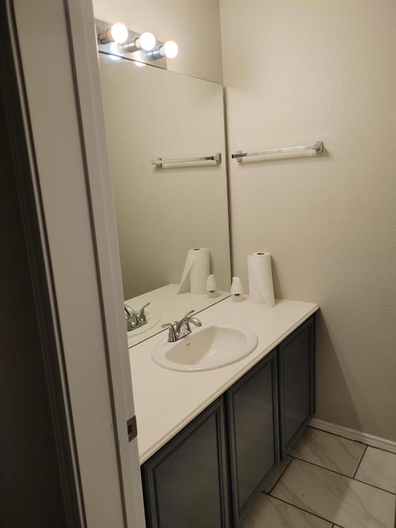 2645 Ezekial Way Plano, TX 75074 - Photo 8 of 16 a bathroom with a sink and mirror