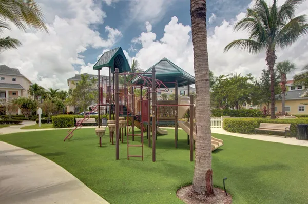 a swimming pool with outdoor seating water slide and fire pit