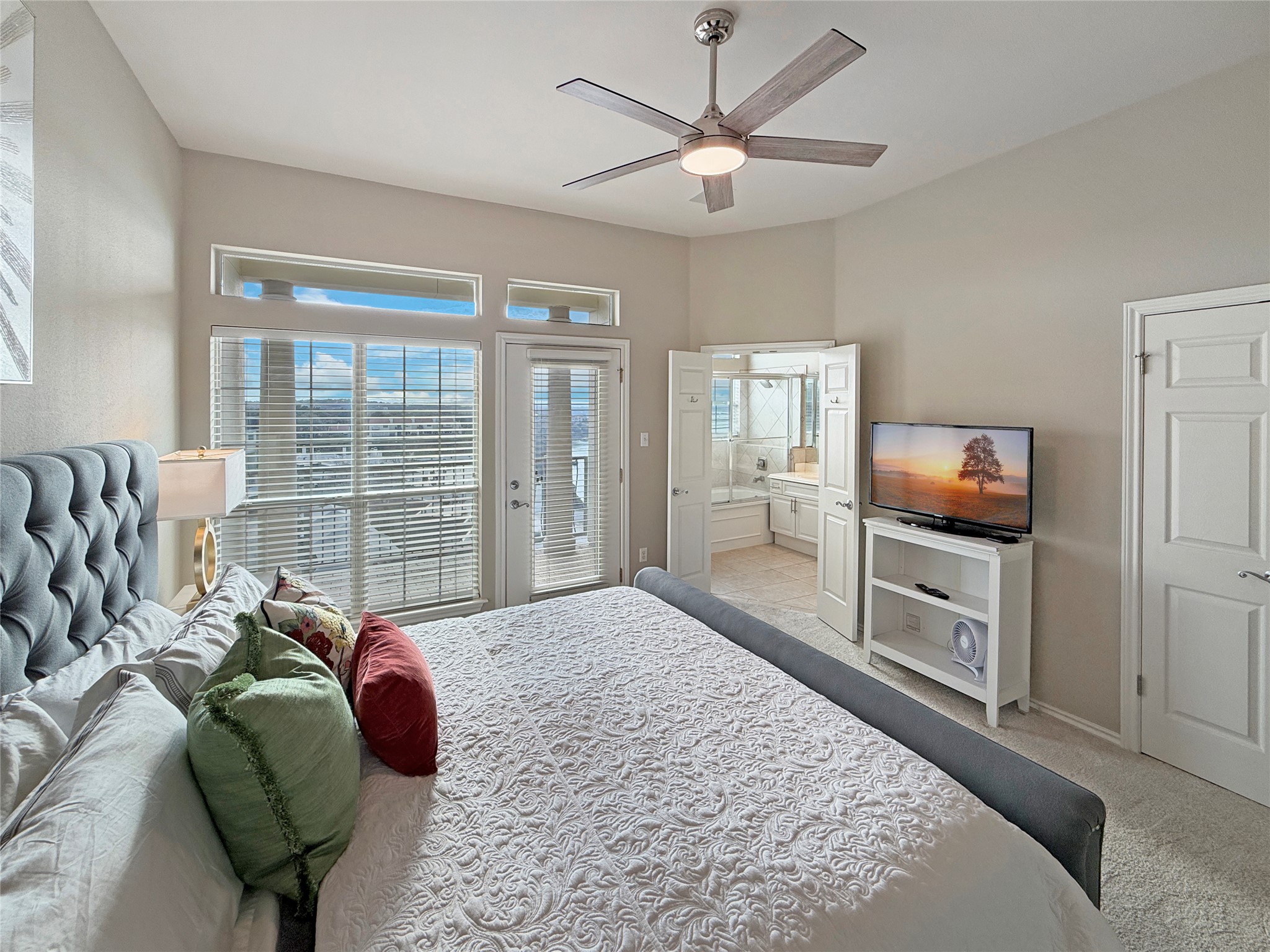 2918 Ranch Road 620 North, Unit Y199 Austin, TX 78734 - Photo 22 of 39 a living room with furniture a flat screen tv and a floor to ceiling window