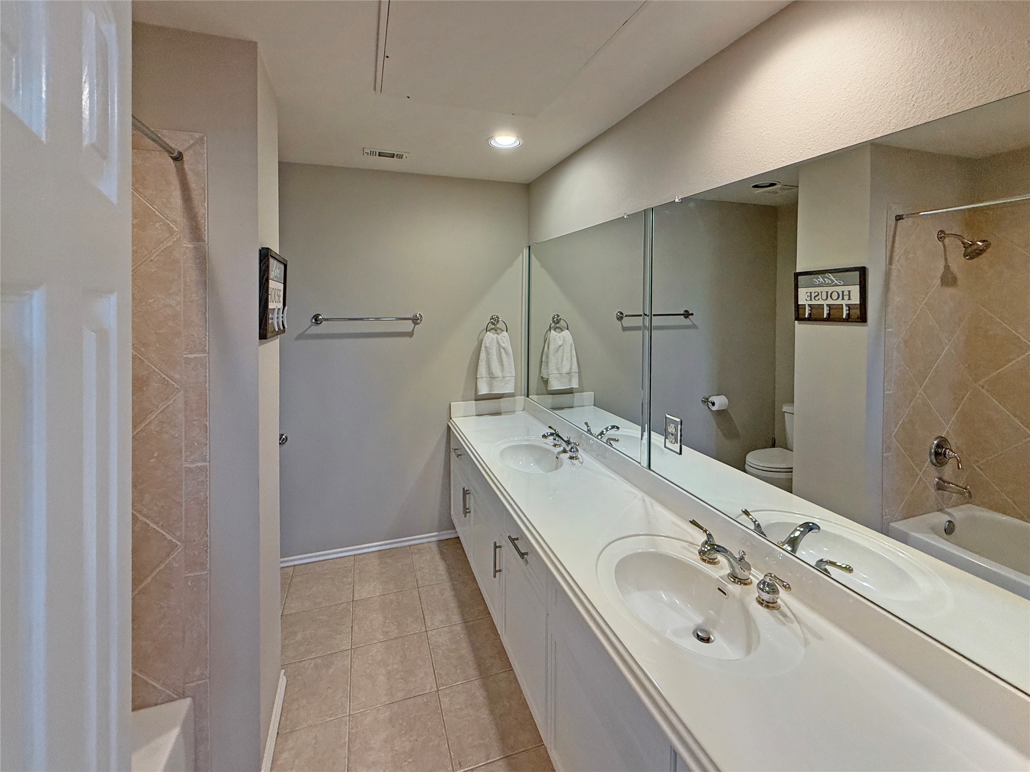 2918 Ranch Road 620 North, Unit Y199 Austin, TX 78734 - Photo 29 of 39 a bathroom with double vanity sink and mirror