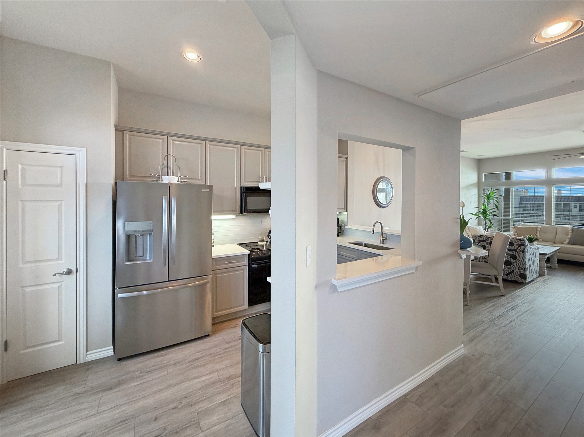 2918 Ranch Road 620 North, Unit Y199 Austin, TX 78734 - Photo 6 of 39 a kitchen with stainless steel appliances a refrigerator a sink a stove and white cabinets with wooden floor