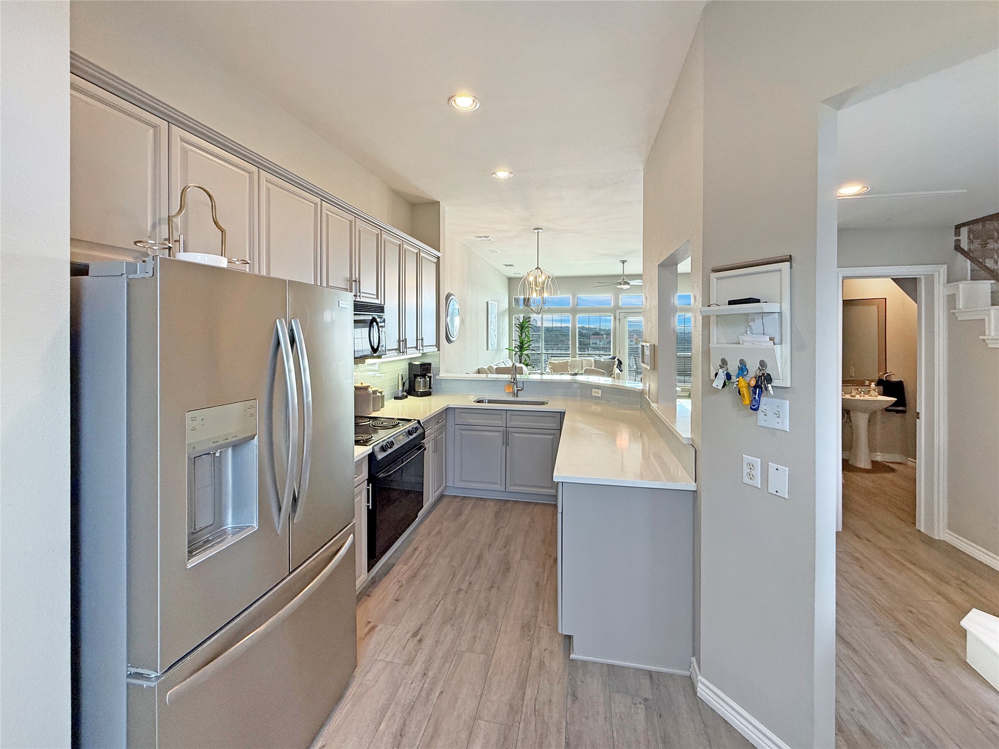2918 Ranch Road 620 North, Unit Y199 Austin, TX 78734 - Photo 7 of 39 a kitchen with stainless steel appliances a refrigerator a sink and white cabinets